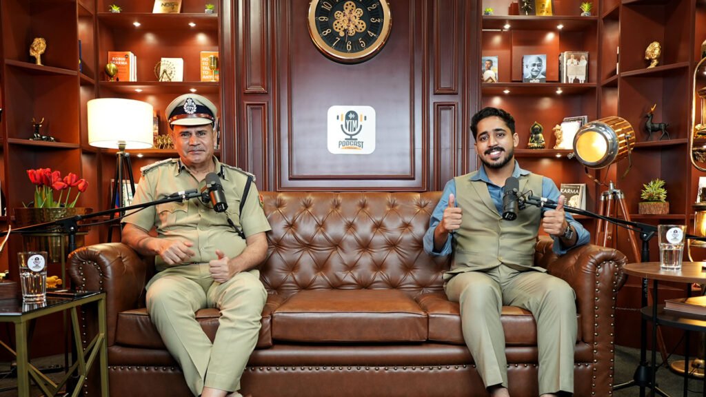 Two guests in uniform recording a podcast on a leather sofa in Oskillo Studio's library-style set