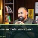Speaker on a Shure mic in a dark wood office-style podcast set at Oskillo Studio, Jaipur